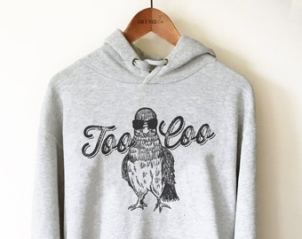 May include: A gray hooded sweatshirt with a black and white illustration of a pigeon wearing sunglasses and the text "Too Coo" in a stylized font.