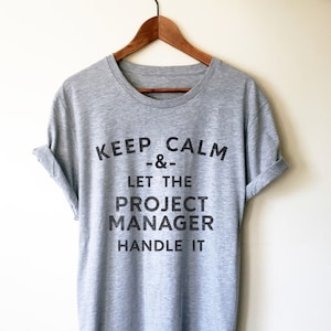 May include: Gray t-shirt with the text "KEEP CALM --&-- LET THE PROJECT MANAGER HANDLE IT" printed in black.