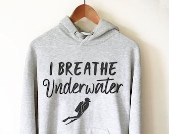 May include: A gray hooded sweatshirt with the text "I breathe underwater" and a silhouette of a scuba diver.