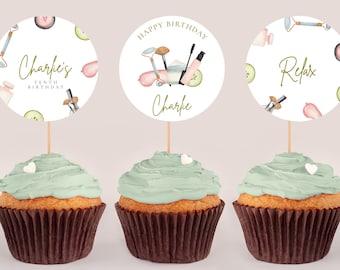 May include: Three cupcakes with green frosting and brown wrappers. Each cupcake has a round, white paper topper with a spa-themed design. The toppers feature illustrations of beauty products, cucumber slices, and the text "Charlie's Tenth Birthday", "Happy Birthday Charlie", and "Relax".