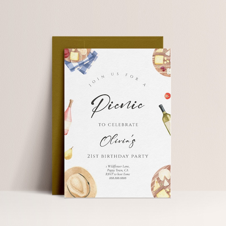 May include: A white invitation card with a watercolor illustration of a picnic basket, wine bottles, cheese, and a hat. The text on the card reads "Join us for a Picnic to celebrate Olivia's 21st Birthday Party. Wildflower Lane, Poppy Town, CA. RSVP to host Esme 888.888.8888"