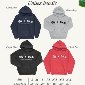 May include: Unisex hoodie in four colors: classic navy, classic black, classic grey, and classic red. The hoodie features the text "Twin Dad Always Overachieving" in a white circle on the front. The hoodie is available in sizes S-4XL with chest measurements ranging from 40 inches to 64 inches.