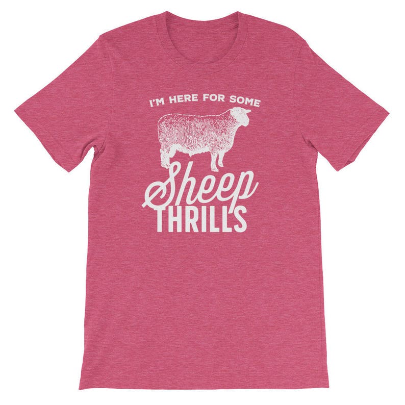 May include: A pink heather t-shirt with a white graphic of a sheep and the text "I'm here for some sheep thrills".