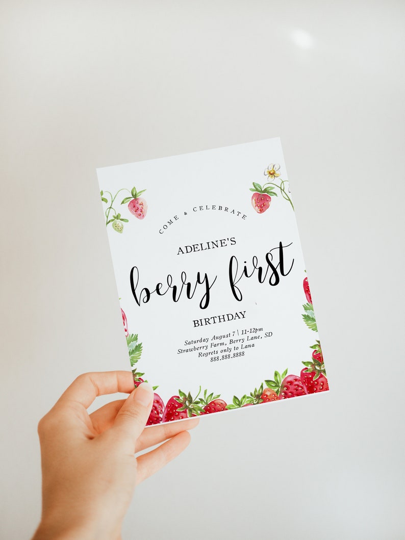 May include: A pink and green invitation card with a strawberry design. The text reads "Come Celebrate Adeline's Berry First Birthday. Saturday August 7, 11-12pm Strawberry Farm, Berry Lane, SD. Regrets only to Lana 888.888.8888"