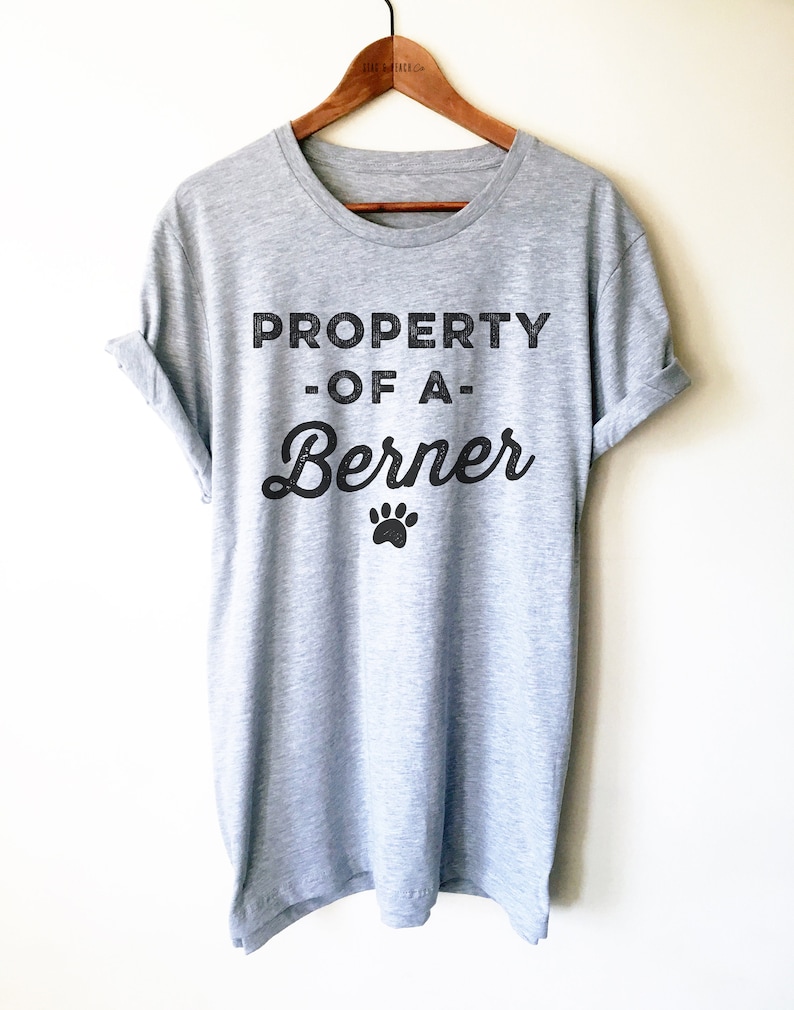 May include: Gray t-shirt with black text that reads "PROPERTY OF A Berner" with a paw print below the text.
