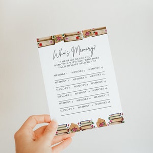 May include: A printable game card with the title "Who's Memory?" and instructions for a bridal shower game. The bride reads memories with her guests and they guess who each memory belongs to. The card is decorated with a watercolor illustration of books and roses.
