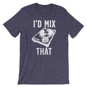 May include: Navy blue t-shirt with the text "I'D MIX THAT" above and below a white illustration of a turntable. The graphic has a distressed, vintage look. The shirt is short-sleeved and made of a soft material.