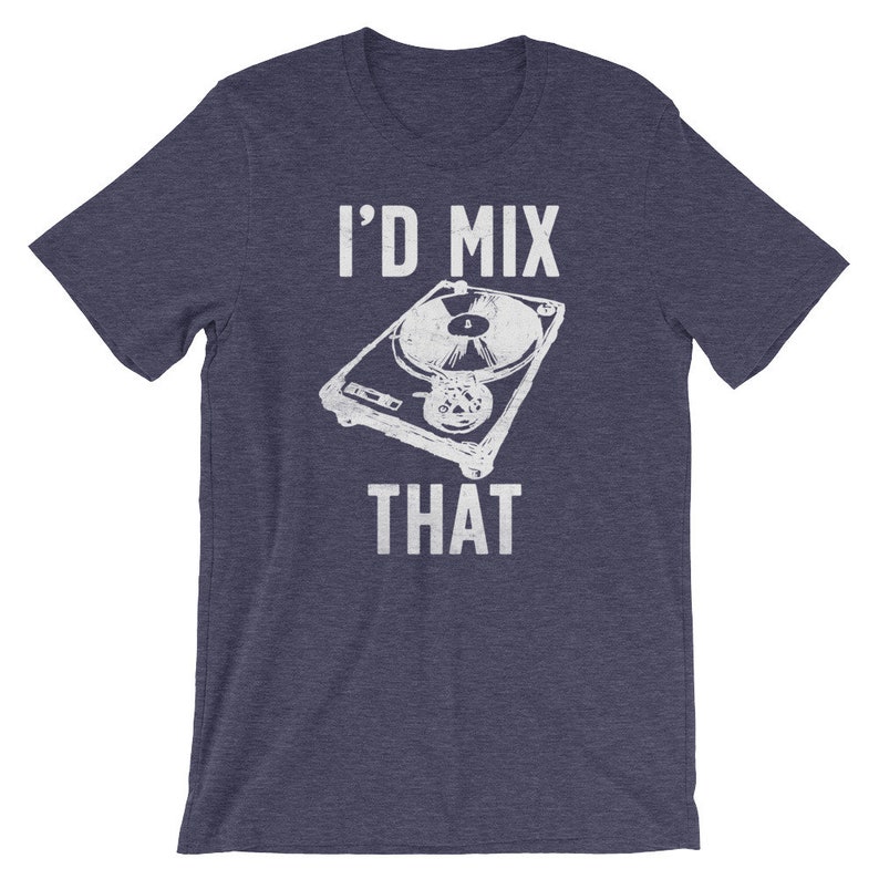 May include: Navy blue t-shirt with the text "I'D MIX THAT" above and below a white illustration of a turntable. The graphic has a distressed, vintage look. The shirt is short-sleeved and made of a soft material.