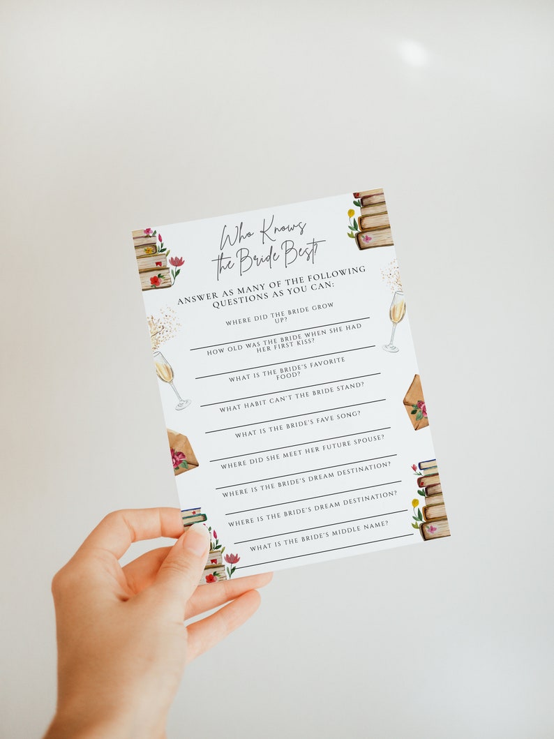 May include: A white card with a pink and green floral design and a stack of books. The card has the text "Who Knows the Bride Best" and a list of questions about the bride.