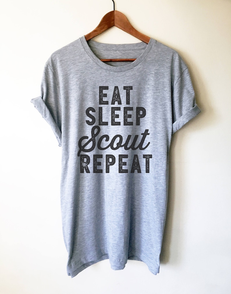 May include: Gray t-shirt with black text that reads "Eat Sleep Scout Repeat".