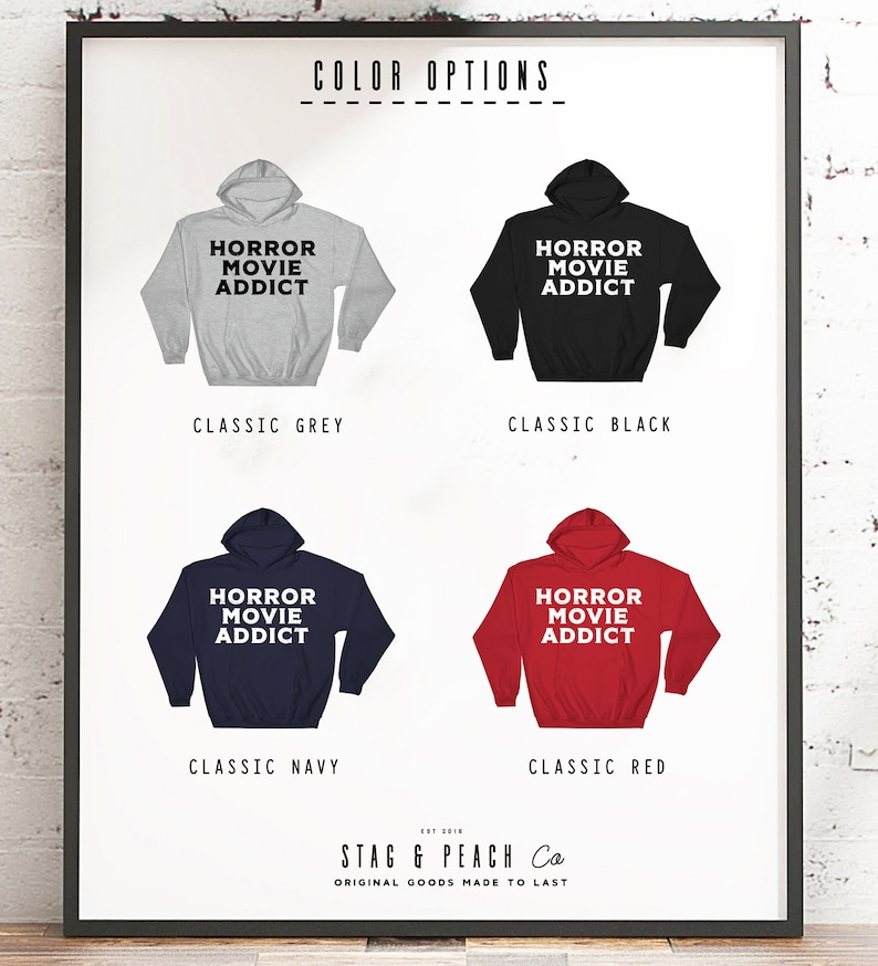 May include: Four different color options for a hoodie with the text "Horror Movie Addict" printed on the front. The colors are classic grey, classic black, classic navy, and classic red.