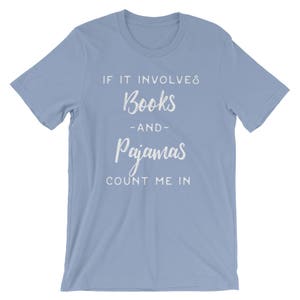 May include: Light blue t-shirt with white text that reads "If it involves books -and- pajamas count me in."
