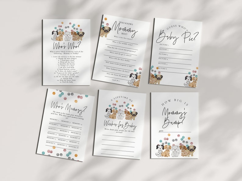 May include: A set of printable baby shower game cards featuring a cute cartoon dog theme. The cards include games like "Who's Who?", "Who's Memory?", "Guess Who's Baby Pic?", "A Lifetime of Wishes for Baby", and "How Big is Mommy's Bump?"