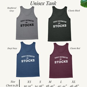 May include: A unisex tank top in five different colours: heather grey, classic black, deep navy, classic red, and white. The tank top features the text "EASILY DISTRACTED -BY- STOCKS" in black lettering. The tank top is available in sizes XS, S, M, L, and XL. The chest measurements for each size are listed below the tank tops.