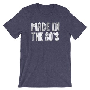 May include: A navy blue t-shirt with white text that reads "MADE IN THE 80'S".