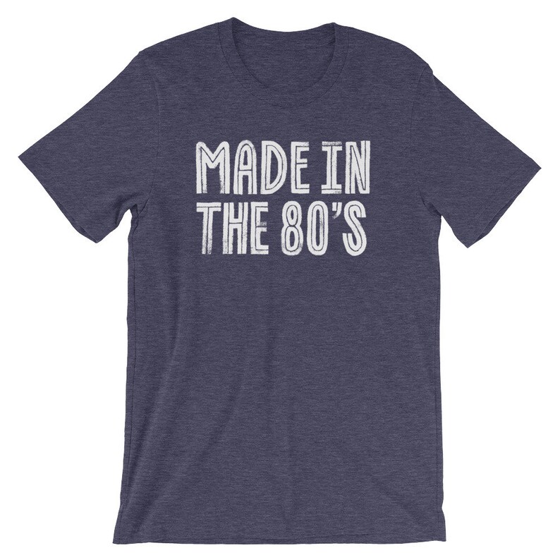 May include: A navy blue t-shirt with white text that reads "MADE IN THE 80'S".