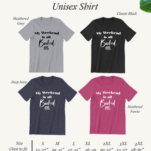 May include: Unisex t-shirt with the text "My Weekend is all Booked." in white lettering on a stack of books. The shirt is available in five colors: heather grey, classic black, deep navy, heather fuscia, and white. The shirt sizes range from S to 4XL with corresponding chest measurements in inches.