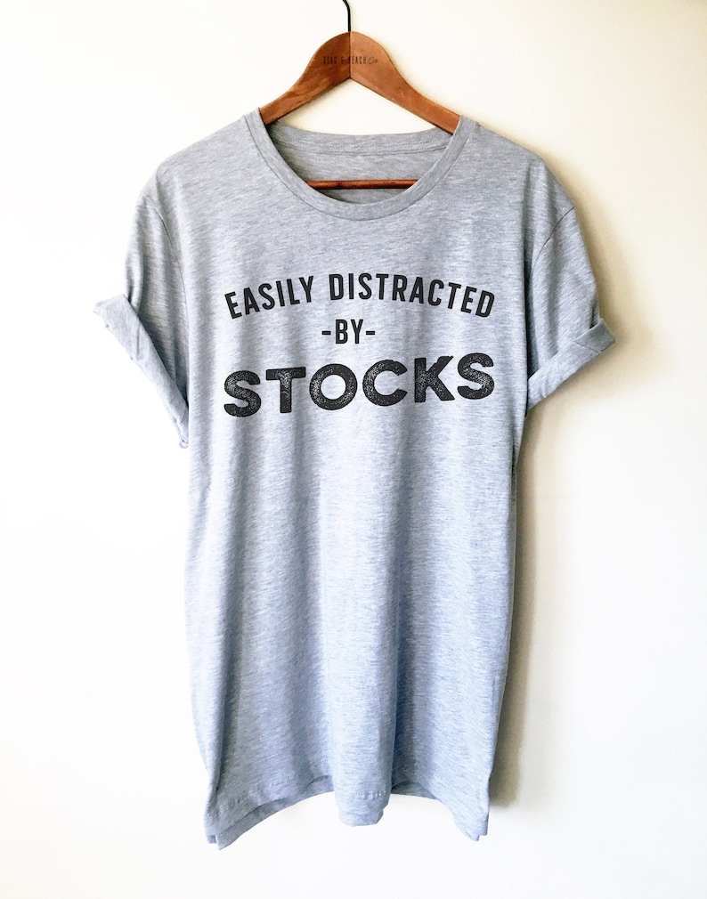May include: Grey t-shirt with the text "EASILY DISTRACTED -BY- STOCKS" printed on the front.