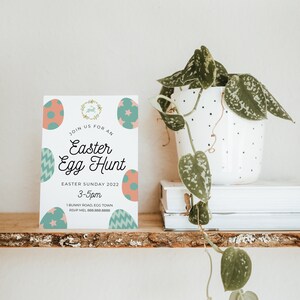 May include: A white card with a colorful Easter egg design. The card reads "Join us for an Easter Egg Hunt, Easter Sunday 2022, 3-5pm, 1 Bunny Road, Egg Town, RSVP Mel 888.888.8888".