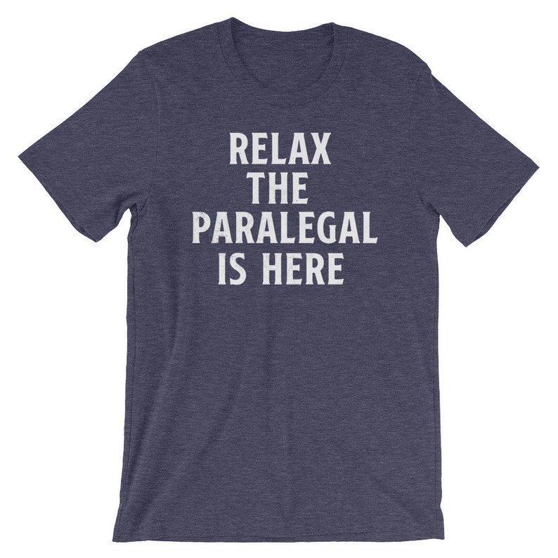 May include: A dark blue t-shirt with white text that reads "Relax the Paralegal is Here".