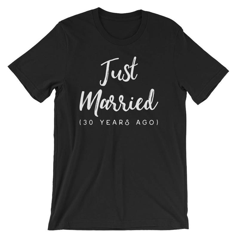 May include: Black t-shirt with white text that reads "Just Married (30 Years Ago)"