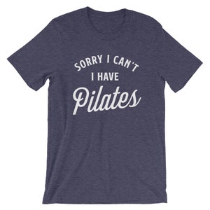 May include: A navy blue t-shirt with the text "Sorry I can't I have Pilates" in white.