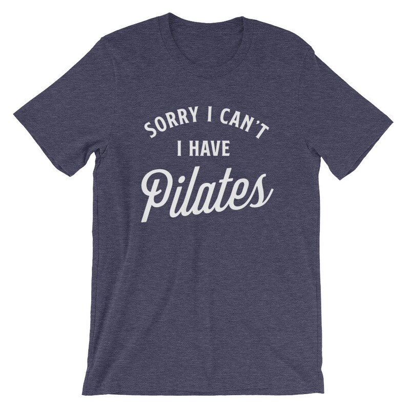 May include: A navy blue t-shirt with the text "Sorry I can't I have Pilates" in white.