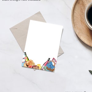 May include: A white card with a watercolor illustration of a picnic basket, wine bottles, fruit, and other picnic items. The text "STAG & PEACH Co." is at the bottom of the card.