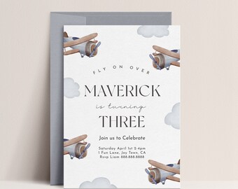 May include: A blue and brown airplane themed birthday invitation for a boy turning three. The invitation features the text "FLY ON OVER MAVERICK is turning THREE" and details for the party, including the date, time, location, and RSVP information.