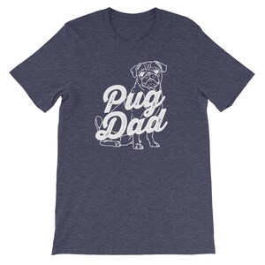 May include: A dark blue t-shirt with a white pug silhouette and the text "Pug Dad" in a vintage-style font.