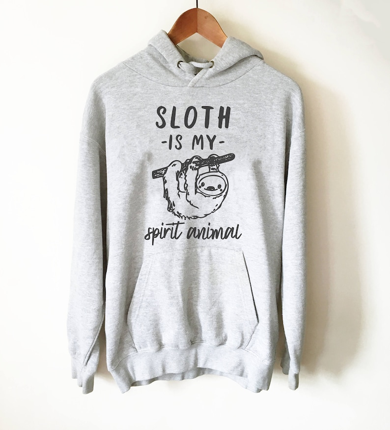 May include: Gray hooded sweatshirt with a black graphic of a sloth hanging from a branch. The text "Sloth -is my- spirit animal" is printed below the sloth.