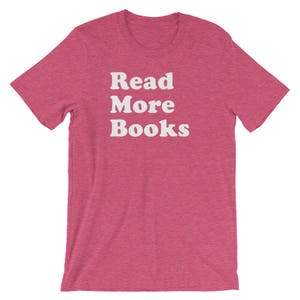 May include: A pink t-shirt with the text "Read More Books" in white.