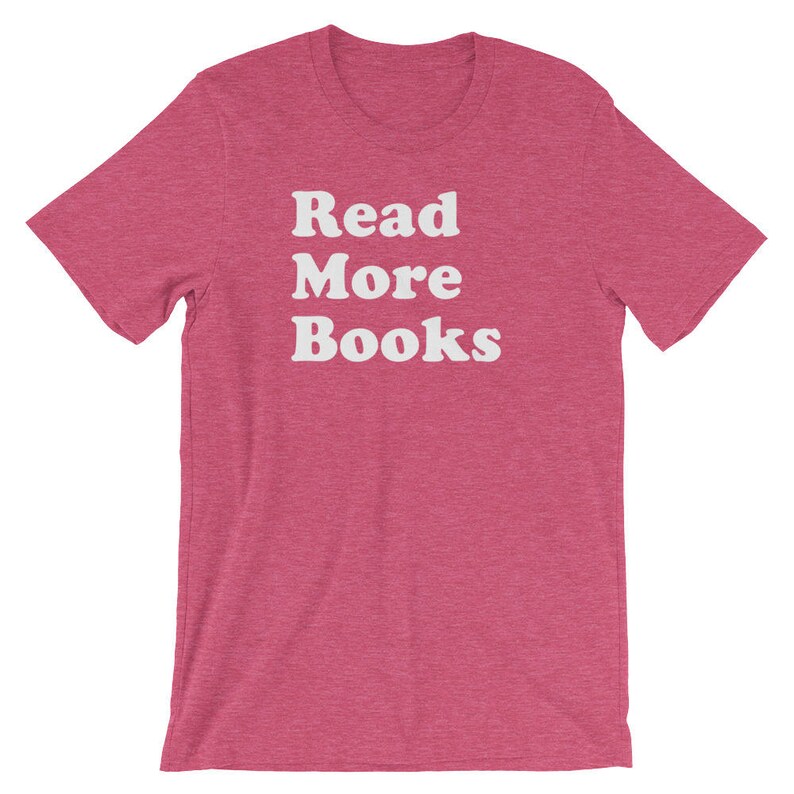 May include: A pink t-shirt with the text "Read More Books" in white.