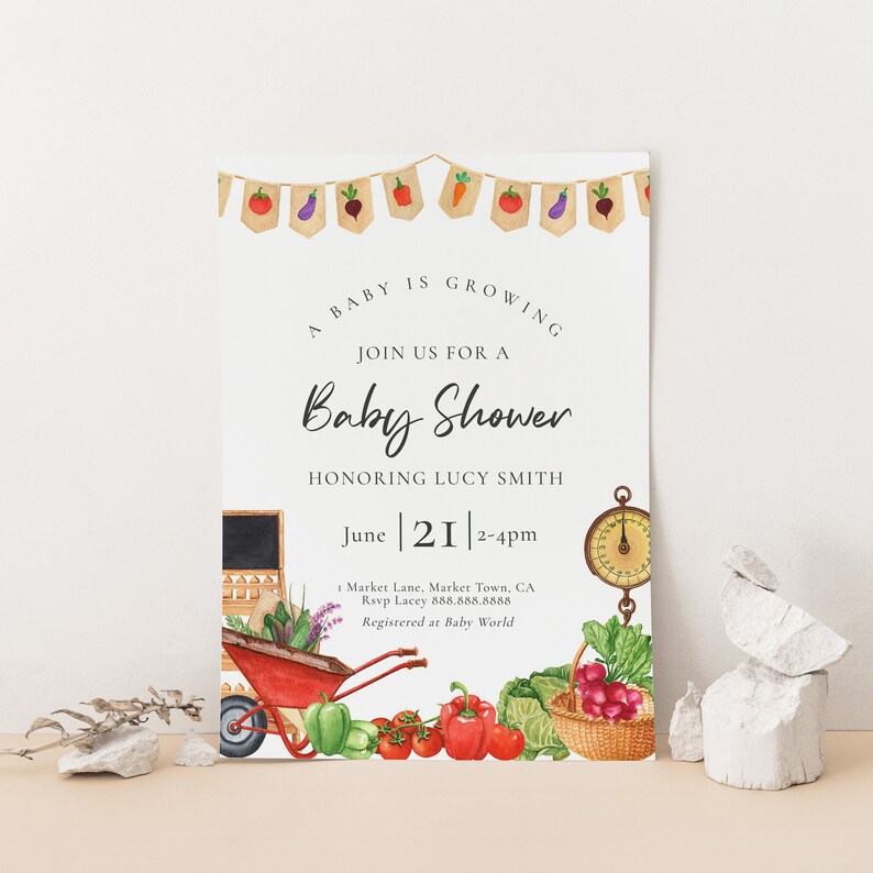 May include: A baby shower invitation with a garden theme. The invitation features a red wagon filled with vegetables, a scale, and a chalkboard with the text "June 21 2-4pm".