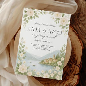 May include: A wedding invitation featuring the names Anya & Nico, with the text "are getting married" and the date August 7-10th 20xx. The invitation has a floral border with a watercolor illustration of a lake and buildings.