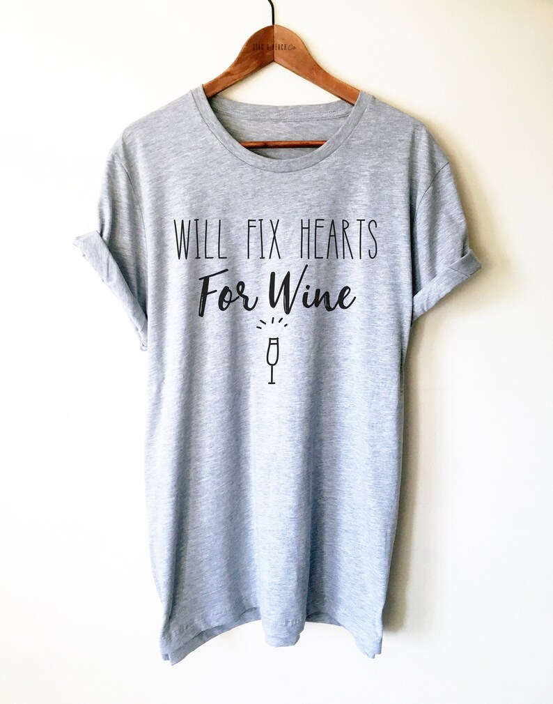 May include: Gray t-shirt with the text "Will Fix Hearts For Wine" and a wine glass icon.