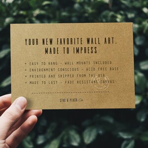 May include: A brown card with the text "YOUR NEW FAVORITE WALL ART. MADE TO IMPRESS" and a list of features: "EASY TO HANG - WALL MOUNTS INCLUDED", "ENVIRONMENT CONSCIOUS - ACID FREE BASE", "PRINTED AND SHIPPED FROM THE USA", "MADE TO LAST - FADE RESISTANT CANVAS". The card also has the text "STAG & PEACH Co."