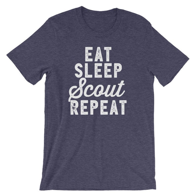 May include: A navy blue t-shirt with a white distressed graphic that reads "Eat Sleep Scout Repeat".