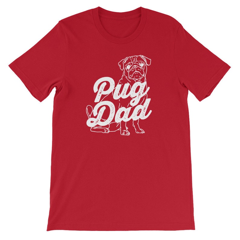May include: Red short-sleeved t-shirt with a white pug illustration and the text "Pug Dad" in a vintage-style font.