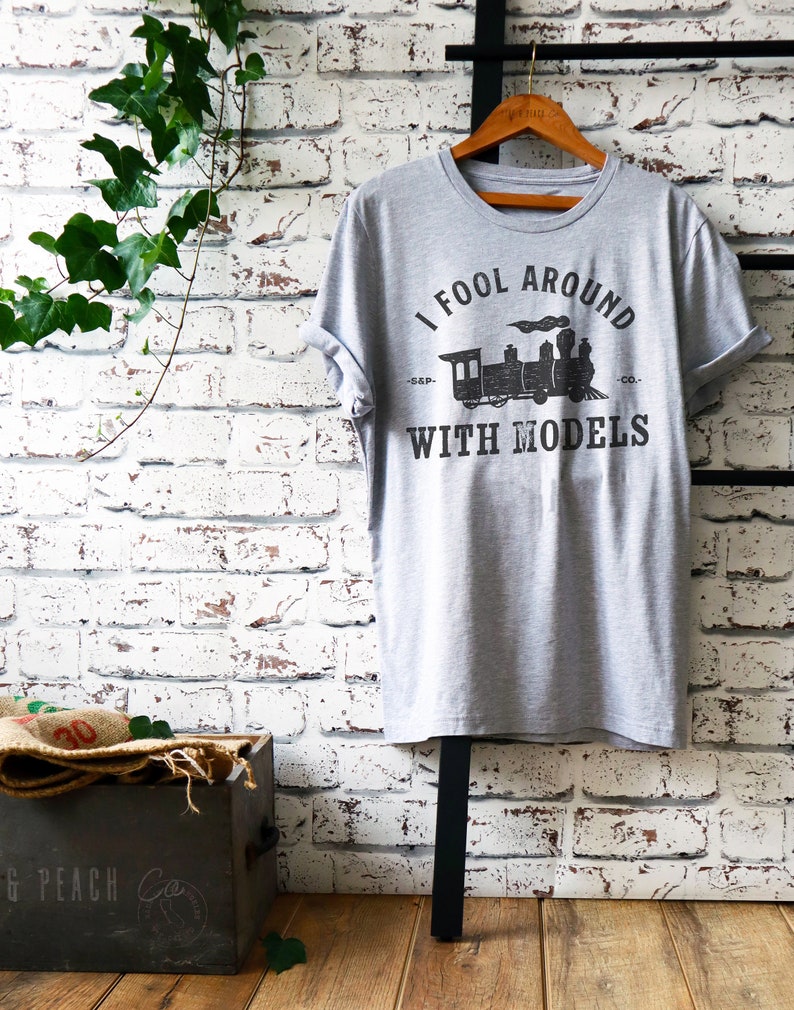 May include: Gray t-shirt with a black and white graphic of a train and the text "I fool around with models -S&P- CO."