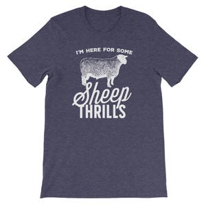 May include: A dark blue t-shirt with a white graphic of a sheep and the text "I'm here for some sheep thrills".