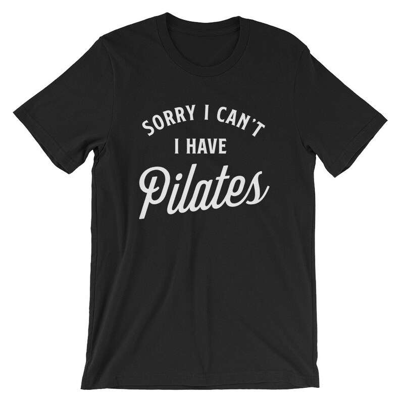 May include: Black t-shirt with white text that reads "Sorry I can't I have Pilates".