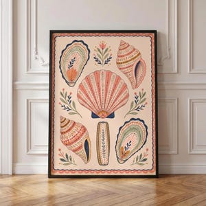 May include: A framed wall art print featuring a collection of illustrated seashells and botanical sprigs on a light peach background. The artwork includes a large central scallop shell, two oyster shells, two spiral shells, and a central vertical element.