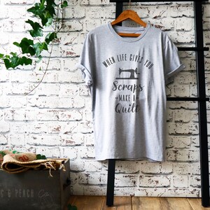 May include: Gray t-shirt with a sewing machine graphic and the text "When life gives you scraps - make a quilt".
