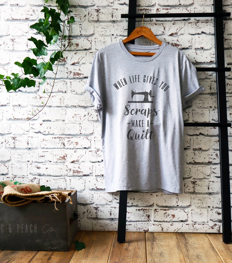 May include: Gray t-shirt with a sewing machine graphic and the text "When life gives you scraps - make a quilt".