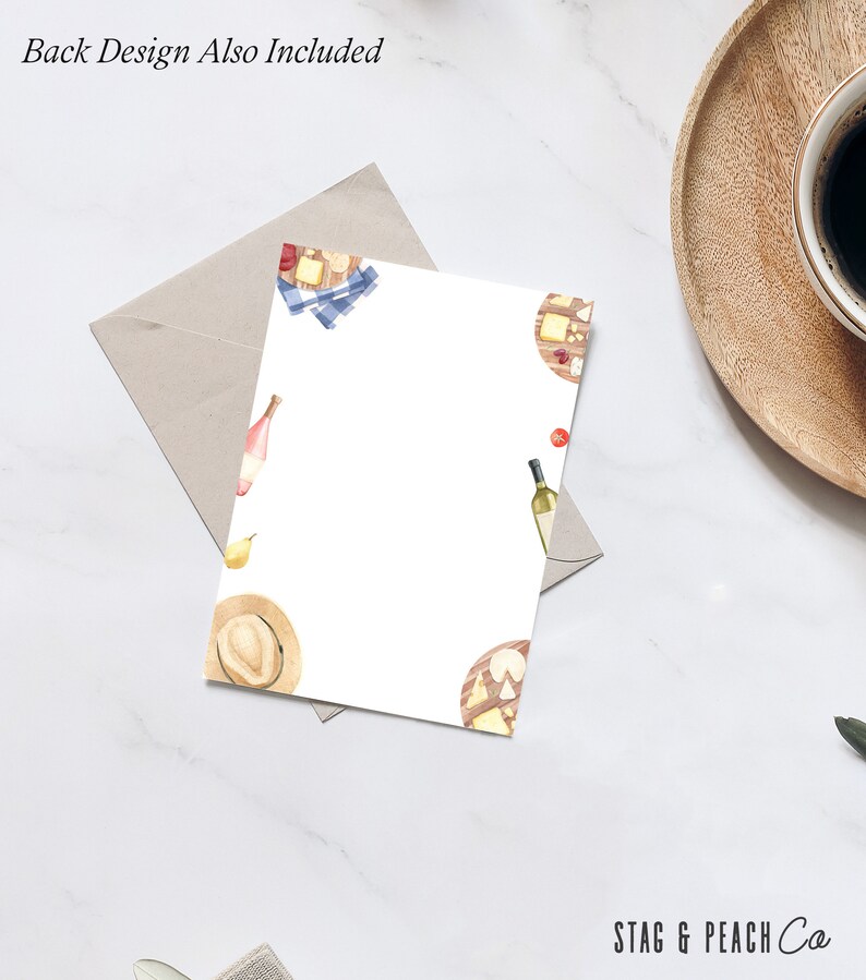 May include: A white card with a watercolor design of a cheese board, wine bottles, and a straw hat. The text "Back Design Also Included" is at the top of the card. The text "STAG & PEACH Co" is at the bottom of the card.