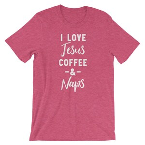 May include: A pink heather t-shirt with the text "I love Jesus Coffee & Naps" in white.