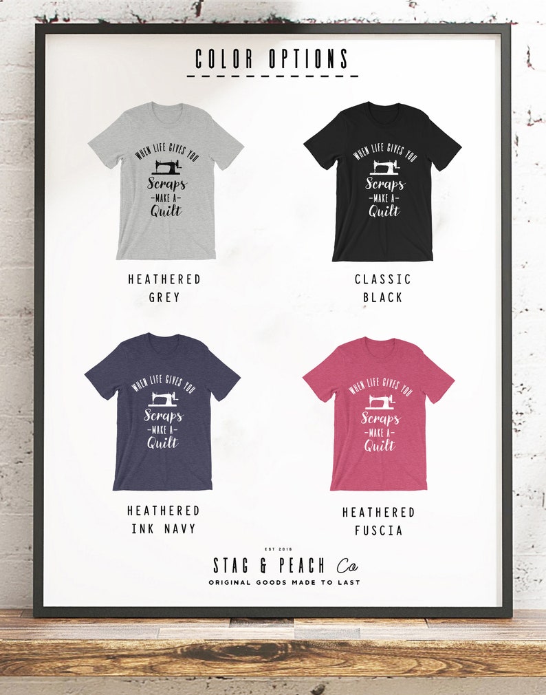 May include: A graphic t-shirt design with a sewing machine and the text "When life gives you scraps - make a quilt". The shirt is available in five colors: heather grey, classic black, heather ink navy, heather fuscia, and white.