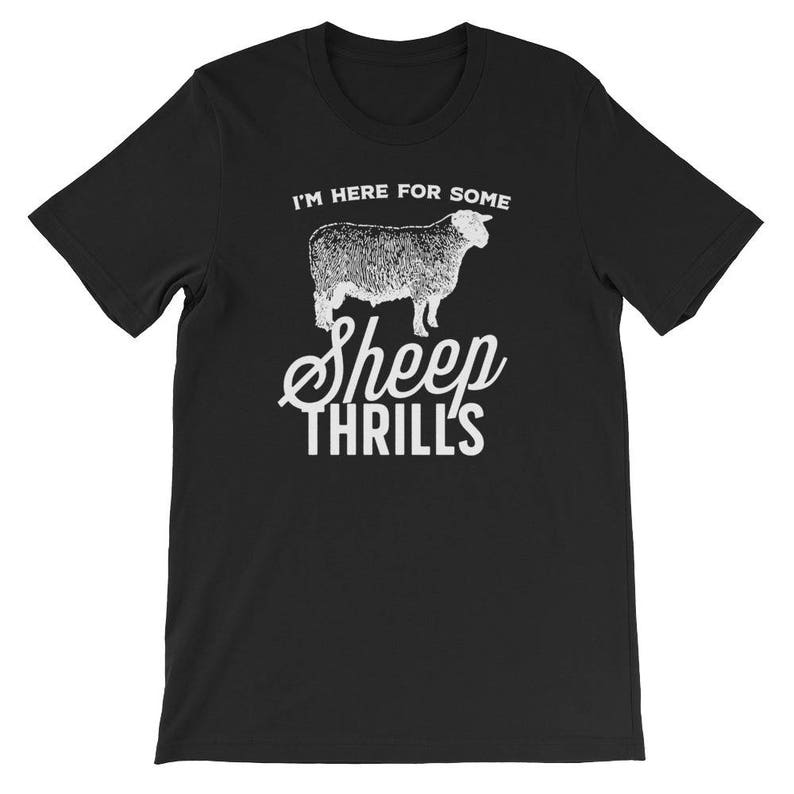 May include: Black t-shirt with white text that reads "I'm here for some sheep thrills" and a white silhouette of a sheep.
