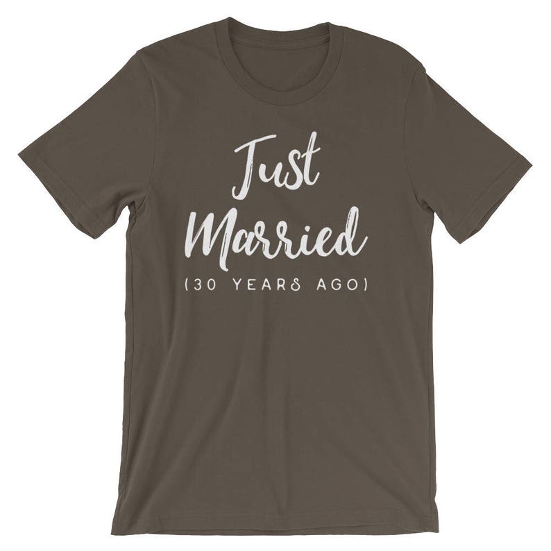 May include: A dark brown t-shirt with the text "Just Married (30 Years Ago)" in white.